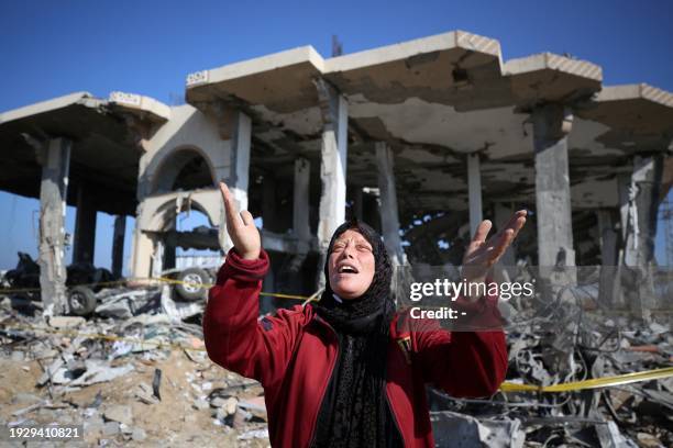 Palestinian woman reacts in front of a destroyed building in the Al-Maghazi refugee camp in the central Gaza Strip on January 16 amid ongoing battles...