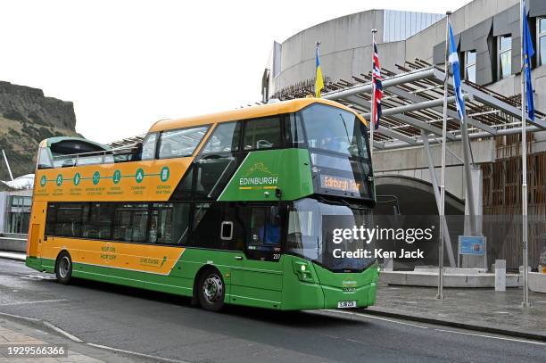 Tour bus passes the Scottish Parliament, as the Parliament prepares to debate the Visitor Levy Bill at Stage 1, on January 16, 2024 in Edinburgh,...