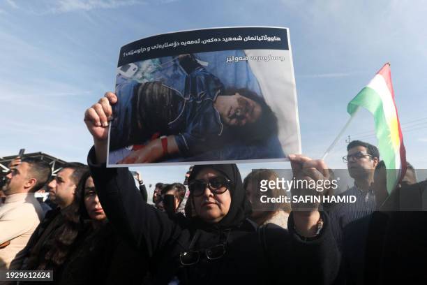Protesters holds a picture of a child's body during a demonstration outside the United Nations office, a day after several areas in the city were hit...