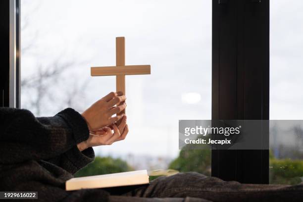 woman praying at home - trust god stock pictures, royalty-free photos & images