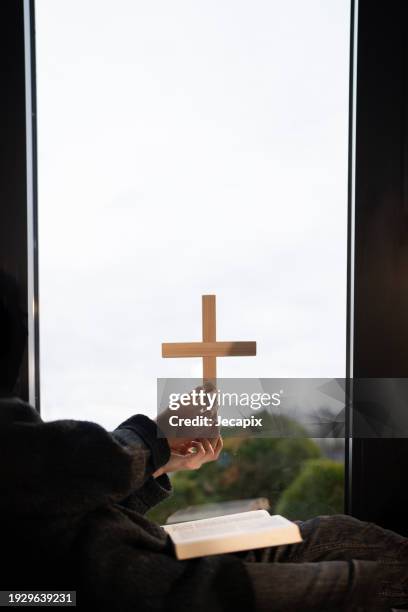 woman praying at home - trust god stock pictures, royalty-free photos & images