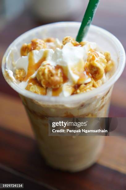 coffee caramel topping with popcorn on wooden table - blended coffee drink stock pictures, royalty-free photos & images