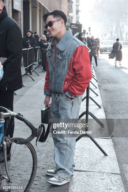 Guest wears paneled denim jacket with red details at Dolce&Gabanna Show, during the Milan Fashion Week - Menswear Fall/Winter 2024-2025 on January...