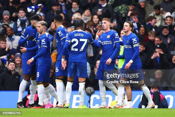 Cole Palmer of Chelsea celebrates with team mates after scoring their sides first goal from the penalty spot during the Premier League match between...
