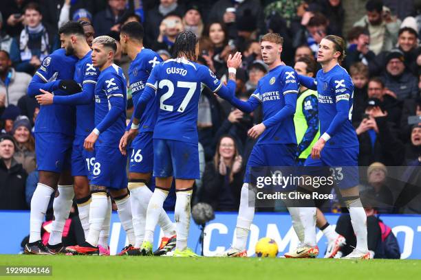 Cole Palmer of Chelsea celebrates with team mates after scoring their sides first goal from the penalty spot during the Premier League match between...