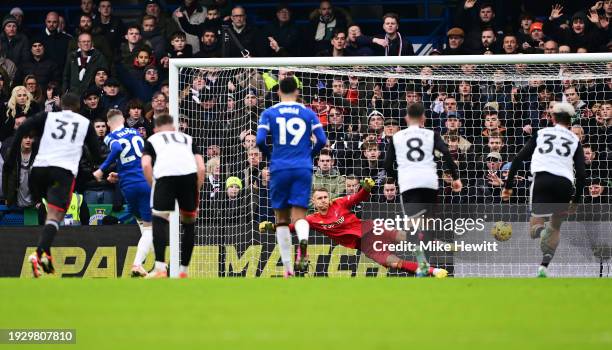 Cole Palmer of Chelsea scores their sides first goal from the penalty spot past Bernd Leno of Fulham during the Premier League match between Chelsea...