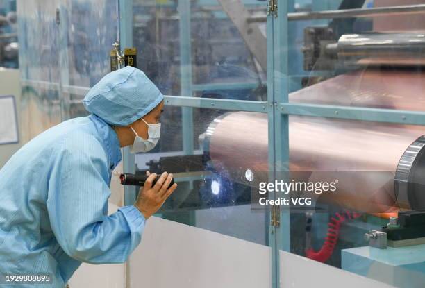 An employee works on the production line of high-performance copper foils at an intelligent workshop of Zhejiang Huanergy Co., Ltd. On January 12,...