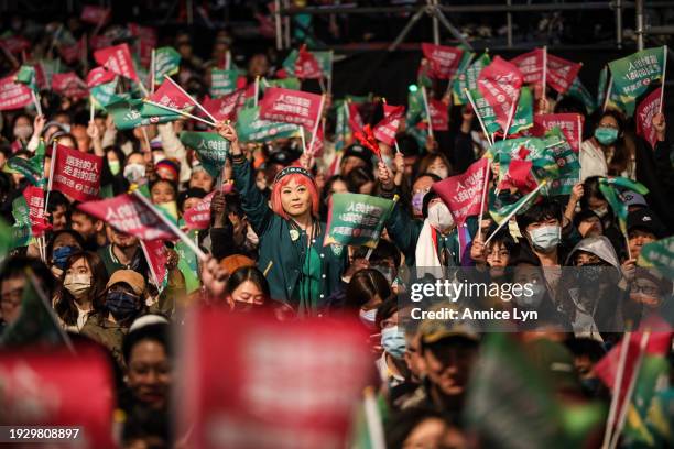 Supporters of Taiwan's Vice President and president-elect from the Democratic Progressive Party Lai Ching-te wait for him to speak at the party's...