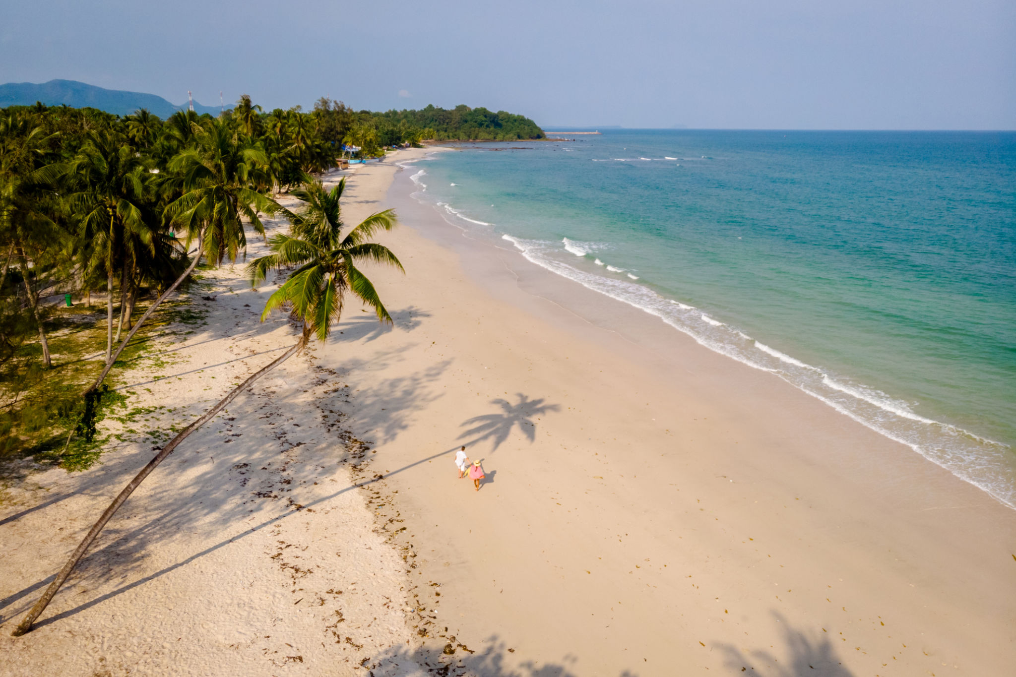 couple on vacation in Thailand, Chumpon province, white tropical beach with palm trees couple on vacation in Thailand, Chumpon province, white tropical beach with palm trees