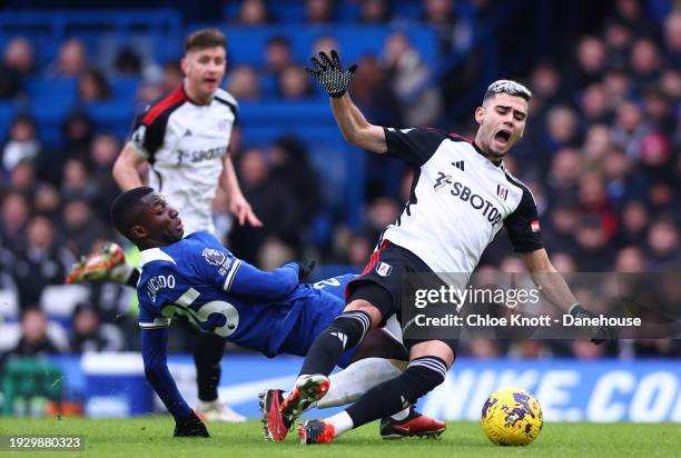 Nicolas Jackson of Chelsea and Andreas Pereira of Fulham FC battle for the ball during the Premier League match between Chelsea FC and Fulham FC at...