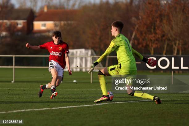 Jayce Fitzgerald of Manchester United U18 scores his team's third goal past Adam Harrison of Newcastle United U18 during the U18 Premier League match...