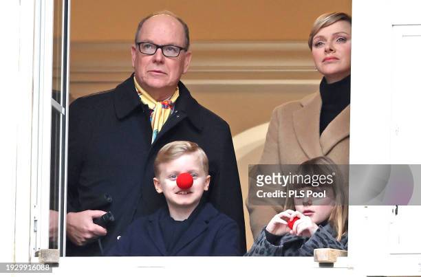 Albert II, Prince of Monaco, Prince Jacques of Monaco, Princess Gabriella of Monaco and Charlene, Princess of Monaco look out of a window during The...