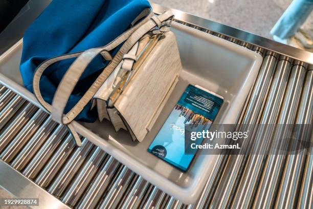 lady's hand luggage on plastic tray going to baggage screening - mic check stock pictures, royalty-free photos & images