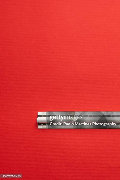 aluminum ruler on red background - centimeter stock pictures, royalty-free photos & images