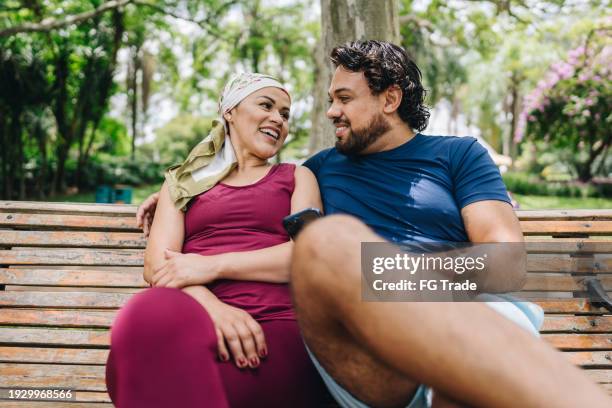 couple talking at park - patient resting stock pictures, royalty-free photos & images