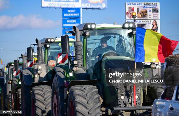 Romanian farmers slowly drive their tractors on the road to Bucharest in Afumati village during protests on January 16, 2024. All over Romania around...