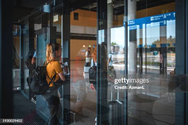 diverse people entering the airport building - lining up stock pictures, royalty-free photos & images