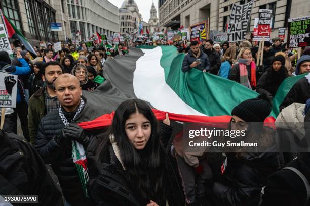 Activists hold a giant Palestinian flag as hundreds of thousands of people join the protest in London on January 13, 2024 in London, England....