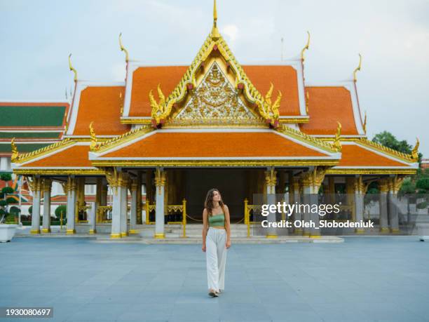 woman exploring temple in bangkok during her vacation - wat stock pictures, royalty-free photos & images