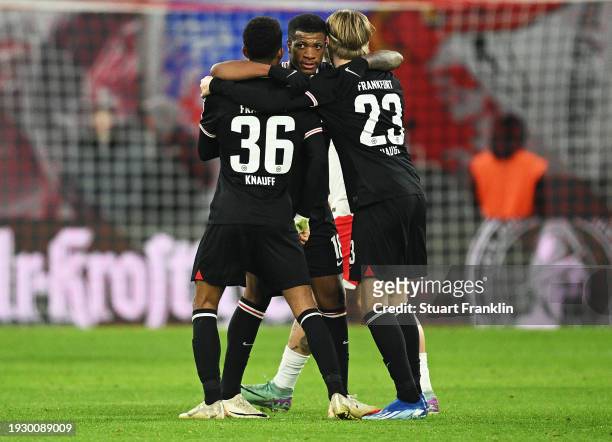 Ansgar Knauff, Jessic Ngankam and Jens Petter Hauge of Eintracht Frankfurt celebrate following their sides victory after the Bundesliga match between...