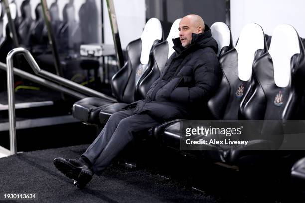 Pep Guardiola, Manager of Manchester City, looks on from the dugout prior to the Premier League match between Newcastle United and Manchester City at...