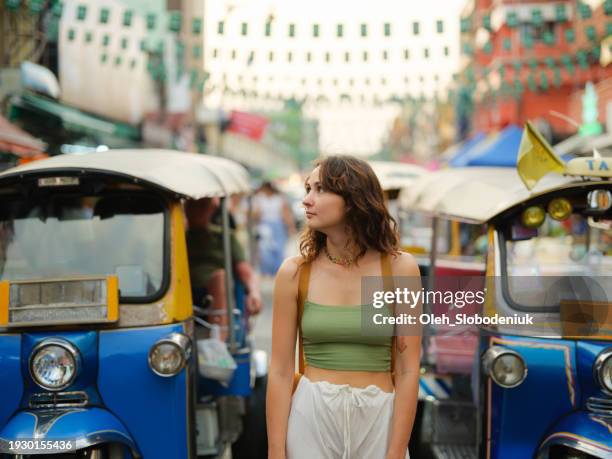 woman exploring khao san road in bangkok during vacation - khao san road stock pictures, royalty-free photos & images