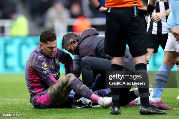 Ederson of Manchester City receives medical treatment during the Premier League match between Newcastle United and Manchester City at St. James Park...