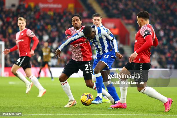 Djeidi Gassama of Sheffield Wednesday is tackled by Kyle Walker-Peters and Chee Adams during the Sky Bet Championship match between Southampton FC...