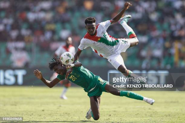 Mauritania's defender Ibrahima Keita clashes with Burkina Faso's forward Abdoul Tapsoba during the Africa Cup of Nations 2024 group D football match...