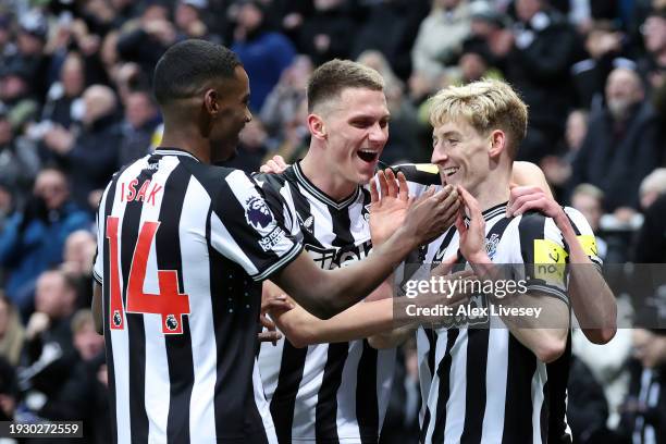 Anthony Gordon of Newcastle United celebrates scoring his team's second goal with teammates during the Premier League match between Newcastle United...