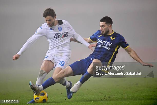 Bartosz Bereszynski of Empoli FC is challenged by Koray Guenter of Hellas Verona FC during the Serie A TIM match between Hellas Verona FC and Empoli...