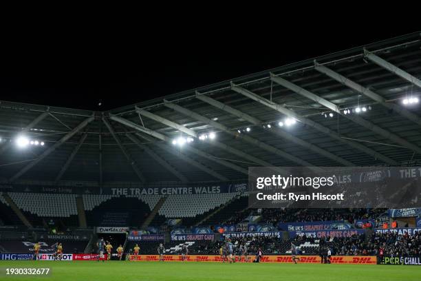 General view of the inside of the stadium, as empty seats can be seen, as players of Ospreys defend against players of USA Perpignan during the EPCR...