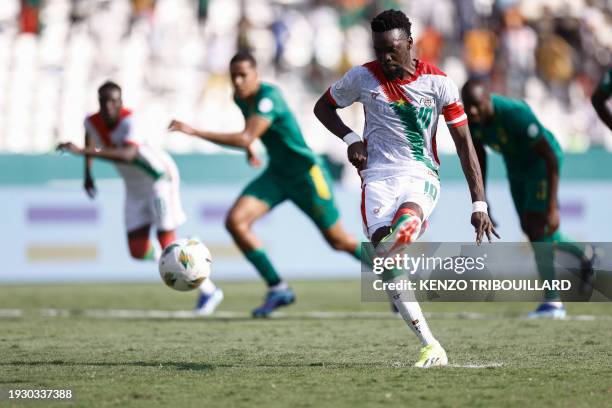 Burkina Faso's forward Bertrand Traore shoots and scores his team's first goal from a penalty kick during the Africa Cup of Nations 2024 group D...