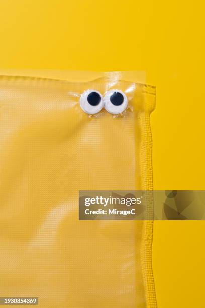 googly eyes trapped in a plastic bag - access control cartoon stock pictures, royalty-free photos & images