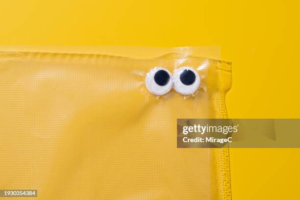 googly eyes trapped in a plastic bag - access control cartoon stock pictures, royalty-free photos & images