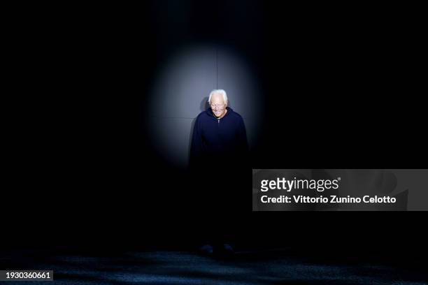 Fashion designer Giorgio Armani acknowledges the applause of the audience at the Emporio Armani fashion show during the Milan Menswear Fall/Winter...