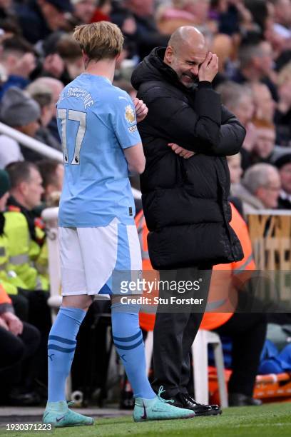 Pep Guardiola, Manager of Manchester City, reacts alongside Kevin De Bruyne during the Premier League match between Newcastle United and Manchester...