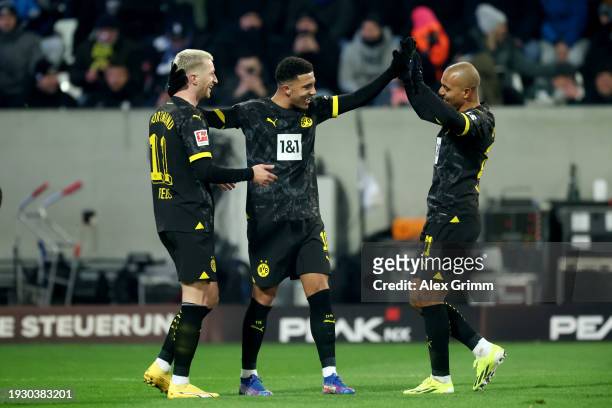 Marco Reus of Borussia Dortmund celebrates scoring his team's second goal with teammates Jadon Sancho and Donyell Malen of Borussia Dortmund during...