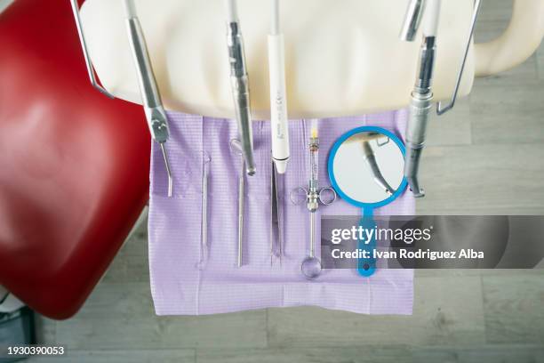dental tools and drills next to dental chair - dental drill stock pictures, royalty-free photos & images