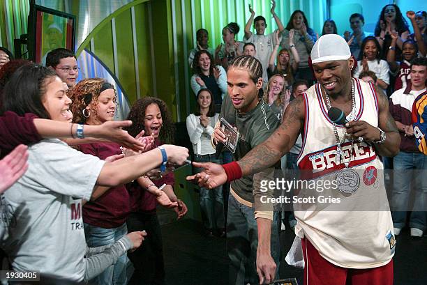 Rapper 50 Cent and VJ Quddus hand out copies of 50's new DVD at the kick off of "TRL High School Week" on MTV at the MTV Times Square Studios April...