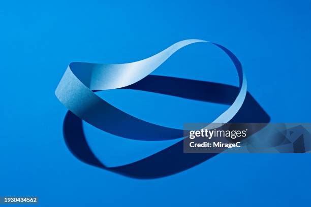 möbius or mobius strip made of blue paper strip - an illusion stock pictures, royalty-free photos & images
