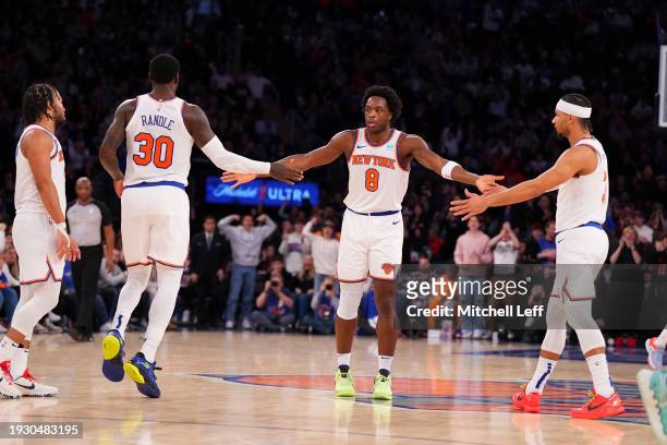 Anunoby of the New York Knicks celebrates with Jalen Brunson, Julius Randle, and Josh Hart against the Minnesota Timberwolves at Madison Square...