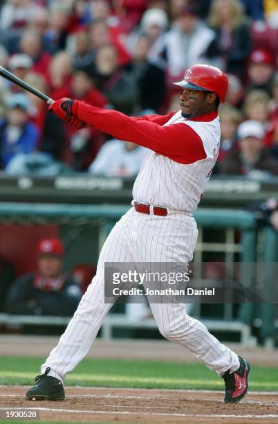 Center fielder Ken Griffey Jr. #30 of the Cincinnati Reds gets the first hit in the new Reds ball park against the Pittsburgh Pirates on opening day...