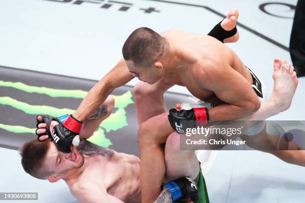 Nikolas Motta of Brazil punches Tom Nolan of Australia in a lightweight fight during the UFC Fight Night event at UFC APEX on January 13, 2024 in Las...