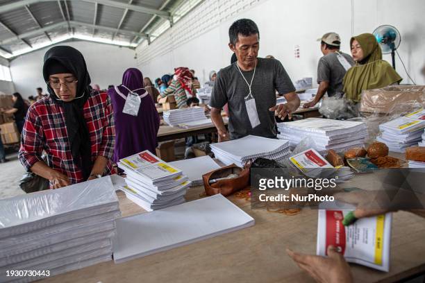 Workers are sorting and folding ballot papers for the upcoming general elections at a logistics warehouse in Jakarta, Indonesia, on January 16, 2024....