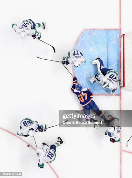 The Vancouver Canucks defend against Anders Lee of the New York Islanders at UBS Arena on January 09, 2024 in Elmont, New York.