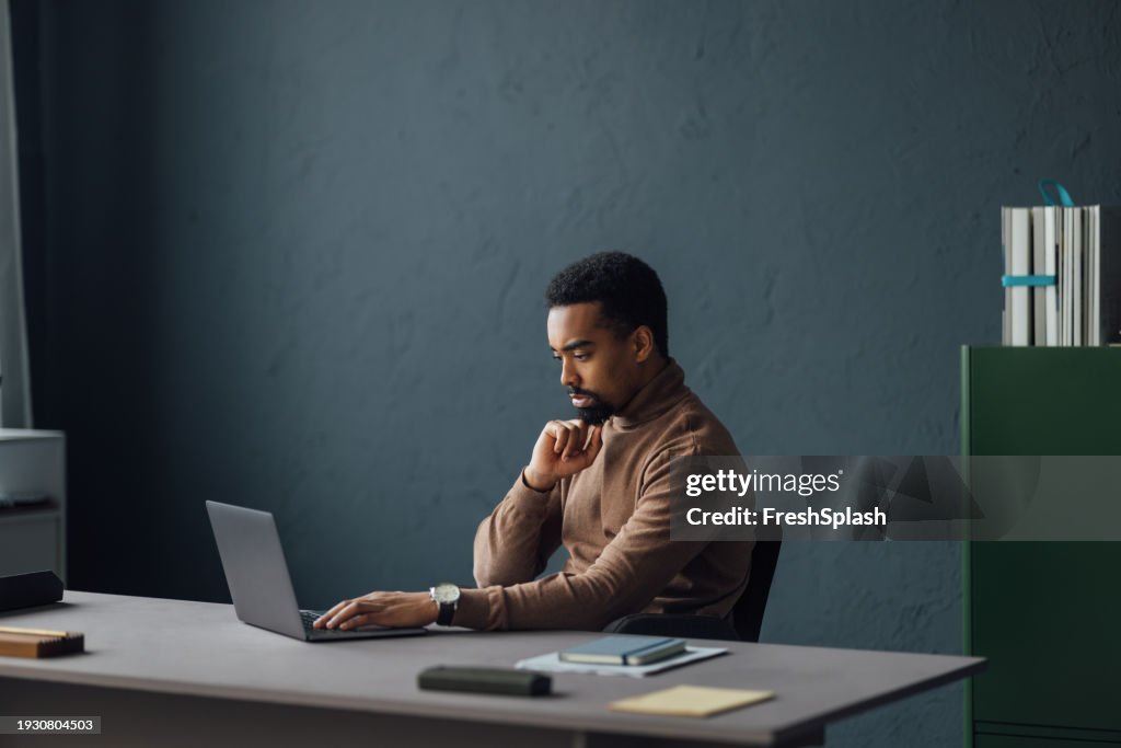 Office Worker Engaged with Laptop Tasks