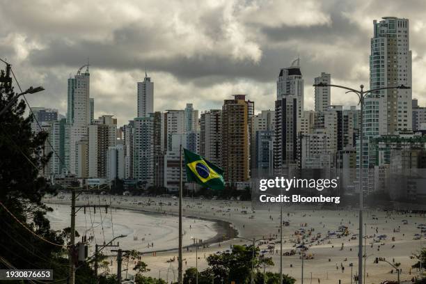 The Brazilian flag flies near a beach in Balneario Camboriu, Brazil, on Tuesday, Dec. 12, 2023. The most expensive real estate in Brazil isn't on the...