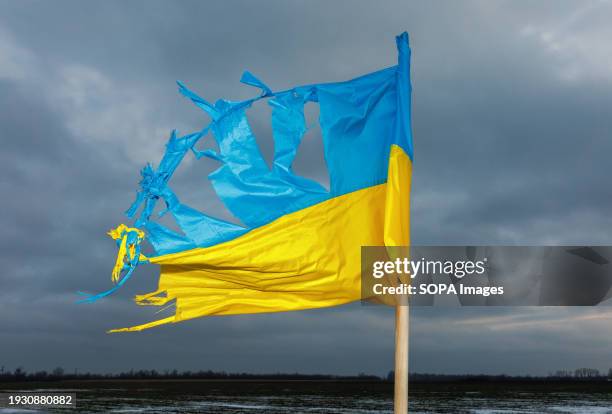 Tattered flag of Ukraine seen in Kharkiv region.