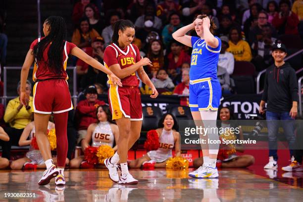 Trojans guard McKenzie Forbes celebrates a turnover on UCLA Bruins forward Lina Sontag during the women's college basketball game between the UCLA...
